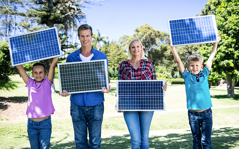 Family Holding Solar Panels Outdoors